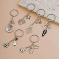 Detailed flat lay of 6 silver metal Halloween keychains with pumpkin and ghost motifs - 6-Piece Halloween Set