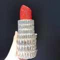 Detail of crystal lipstick clutch featuring a red rhinestone top and silver metal body - Silver Red/Gold Hardware