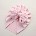 Detailed close-up of pink waffle texture baby turban hat with large decorative bow - 21*17 cm / Light Pink