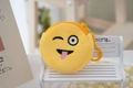 Detail of yellow plush cartoon coin purse with embroidered emoji wink and tongue on a bench - Style 2 (Wink Tongue)