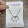 Silver interlocking triple-ring necklace with elegant white pearl accents - Multi-Ring Pearl Style
