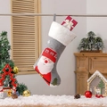 Grey Christmas stocking with plush cuff and Santa Claus motif holding a red gift box - Santa Claus