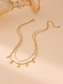 Gold double-layer necklace with star pendant and curved metal bar on pink background - Star / Gold