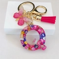 Detail of resin letter Q keychain with pink butterfly and tassel on white base - Rose Red Butterfly Tassel Clip / Letter Q