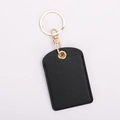 Detail of a black leather key fob holder with gold ring for access control cards - Square / Textured Black