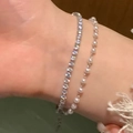Close-up of stacked silver bracelets featuring sparkling cubic zirconia and small round pearls - Silver Zirconia Pearl Layering Set (MY32297)