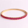 Detailed close-up of luxurious 18K gold plated bracelet with square red zircon stones - Rose Red Zirconia