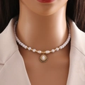 Detail of handmade natural stone necklace with white beads and golden oval gemstone pendant - White Jade Necklace