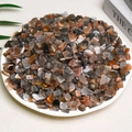 Polished natural grey and orange quartz crystal stones in a white decorative bowl - Black Bone Powder (7-9mm) 100g