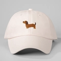Close-up of light pink baseball cap featuring detailed brown dachshund dog embroidery - Adjustable / Beige