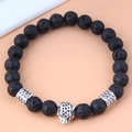 Detail showing porous black lava stone beads and silver leopard head charm on bracelet - Leopard Head
