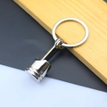Detailed view of creative car engine piston keychain with polished silver metal finish - Narrow Engine Piston / Silver