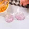 Detailed macro of pink glitter resin shell charms with white star patterns for DIY crafts - Small / Shell - Light Pink