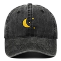 Detailed close-up of yellow moon and star embroidery on washed black cotton baseball cap - Adjustable / Black