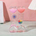 Close-up of heart-shaped liquid timer with pink oil drops and rotating waterwheel - SY01 Cream Windmill Pink Red