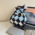 Cute knitted wrist bag with blue and white argyle pattern on a laptop background - Black Blue Diamond