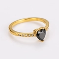 Close-up of golden ring with black heart-shaped gemstone and side pavé zircon details - Gold (Black Zirconia)