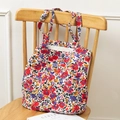 Floral print canvas tote bag hanging on a wooden chair in a minimalist home setting - Full Small Red Flower Print