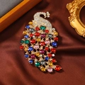 Vintage crystal peacock brooch with colorful rhinestones on a brown silk background - KC Gold