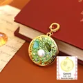 Vintage Gemini zodiac pendant with green rhinestones and pearls on a red antique book - Gemini Style