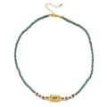 Detail van turquoise kralenketting met een gouden Evil Eye hanger en karabijnslotje - Groenachtige Kralen - Rood-Wit Oog