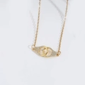 Gold handcuff pendant necklace with micro-pave white zircon and cross chain detail - Interlocking Rings