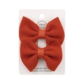 Pair of orange-red bubble fabric bow hair clips for kids on a display card - Rust red