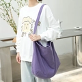 Minimalist purple canvas crossbody bag for women shown with a casual white sweatshirt - Purple