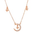 Rose gold moon and star pendant necklace with cubic zirconia accents on white background - Star & Moon Rhinestone Style / Rose Gold