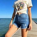 Detail of high waisted distressed denim shorts with frayed hems and Pure Luck graphic t-shirt - S / Bottoms / Light Blue