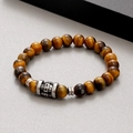 8mm tiger eye stone beaded bracelet with a silver skull charm on a grey textured surface - Tiger Eye Style (KB183247-TLX)