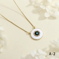 Detailed macro shot of a gold Evil Eye pendant with colorful zircons and white enamel - White Round Style (NE2255-A-2)