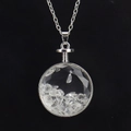 Detailed macro view of a silver circular glass locket filled with natural white crystals - Silver & White Crystal