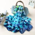 Polka dot chiffon scarf in blue and green gradient draped on a light blue handbag - Large Polka Dot Blue