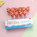 Detailed view of five red polka dot bow birthday candles with elegant party packaging - Cute Polka Dot Red Bow Candle