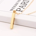 Minimalist gold stainless steel vertical bar pendant necklace on elegant book background - Gold