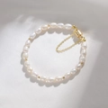 Elegant freshwater pearl bracelet with gold bead spacers and a safety chain detail - Rice-shaped Freshwater Pearl Magnetic Clasp Bracelet