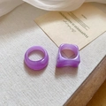 Detail view of purple acrylic ring set on beige textured fabric and decorative card - Purple (2-Piece Set)
