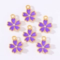 Detail showing six purple enamel cherry blossom charms with rhinestones and gold loops - Purple