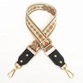 Detail of adjustable woven canvas strap with green geometric patterns and gold metal hooks - No.2 Green Brown Jacquard + Black Leather