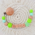 Green and mint silicone bead pacifier clip with beech wood BABY letters on a white mat - Green