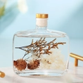 Preserved flowers reed diffuser with pine cones in square glass bottle for home decor - Hilton Style