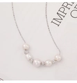 Detail of freshwater pearl necklace with silver beads on a minimalist display card - 925 Silver / White Gold