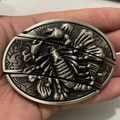 Macro shot of antique silver scorpion relief on a metallic belt buckle accessory - Scorpion