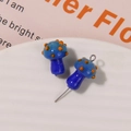 Detailed macro view of two blue glass mushroom beads with orange spots for DIY jewelry - No.17 (Blue Cap Orange Dot Blue Stem)