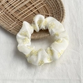 Elegant off-white scrunchie with yellow floral pattern on a woven tray setting - White with Yellow Flowers