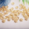 Macro detail of 14K gold-plated star flower bead caps for DIY jewelry making - 9mm Petal / 14K Gold