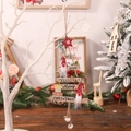 Wooden Christmas tree pendant with Santa Claus figure, stars, and bells hanging on branch - Gnome Wooden Hanging