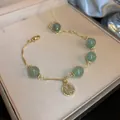 Elegant gold bracelet featuring green jade-like beads and a Fu character charm - Green Fu Character Style (87# Bracelet-Green)