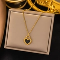 Golden heart pendant necklace with black enamel inlay and beaded chain on display - Black and White Double-sided Heart